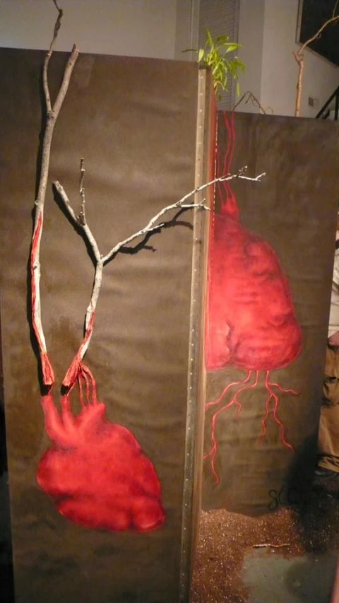 two art pieces with a red tree on one side and a green plant on the other