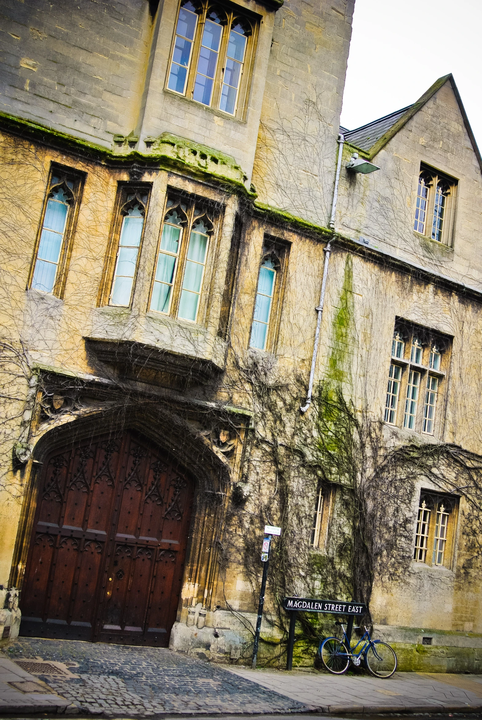 a large old building with windows and a bicycle parked outside