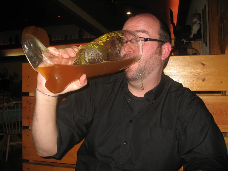 a man is sipping a beverage at a table