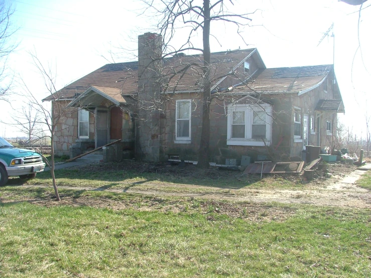 the truck is parked in front of the old brick house