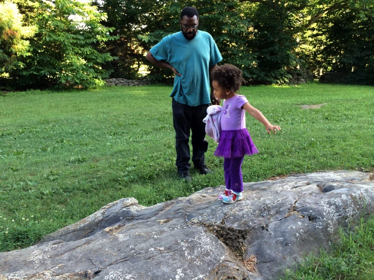 an older man walking with a  in a purple dress