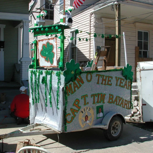 an old car decorated with green shamrocks and shamrock flags