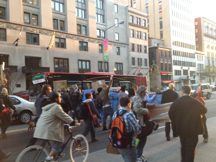 people walk down the street in a busy city