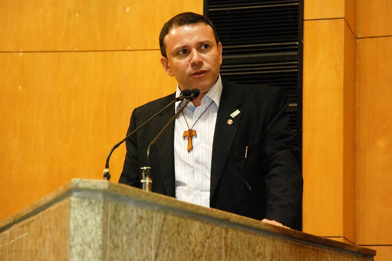 a man giving a speech to an audience