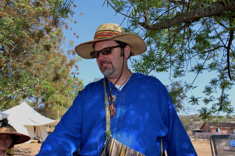 a man with a blue shirt and a hat