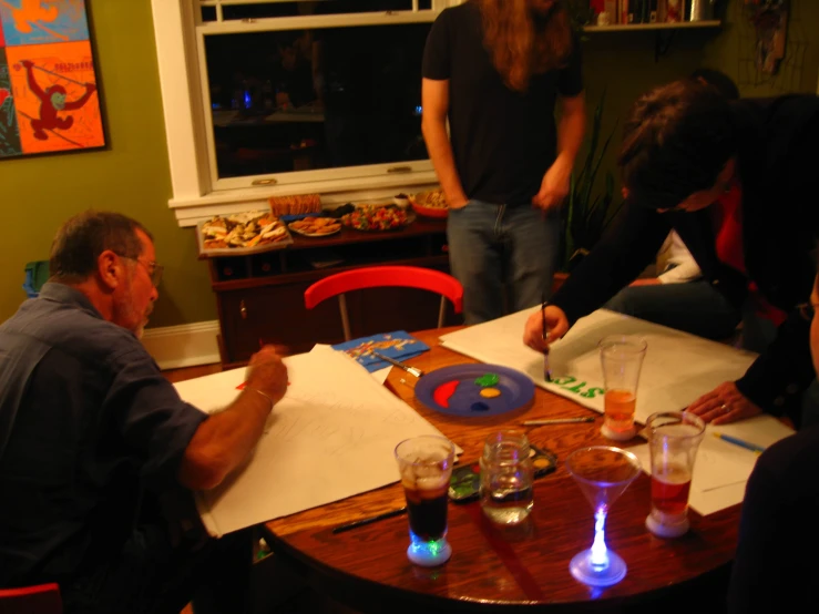 a group of people sitting around a wooden table