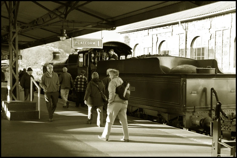 people walking outside of a train car and platform