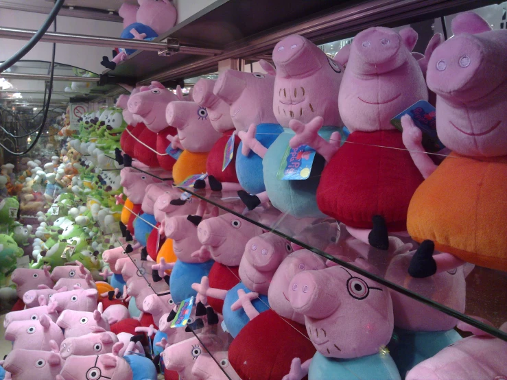 peppa pig stuffed animals in an indoor area