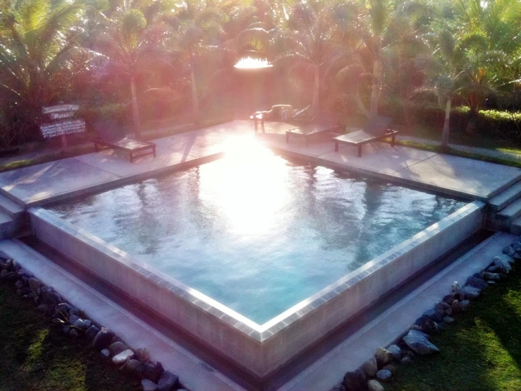 an open air pool with some benches near it