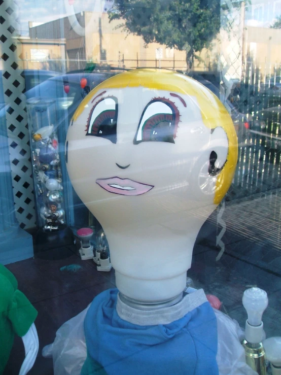 a close up of a person in a store window with a hair dryer