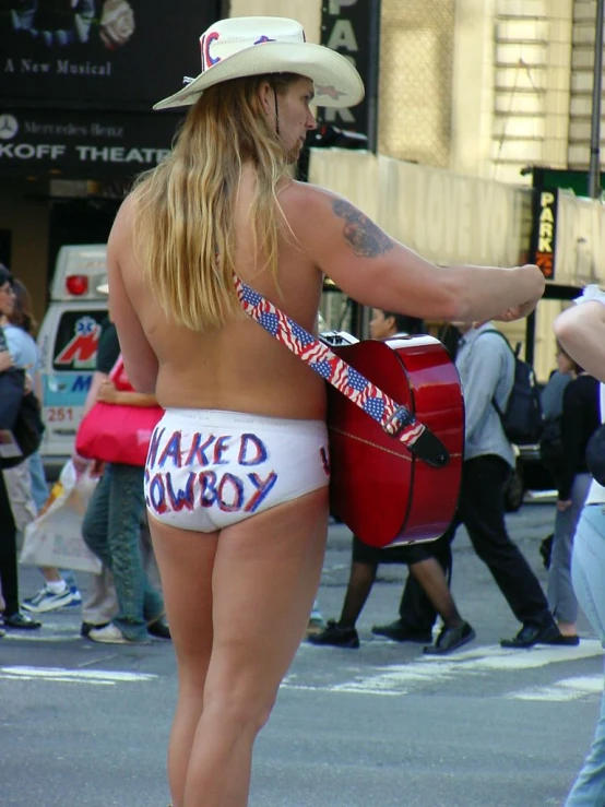 a woman with no pants is walking on the street