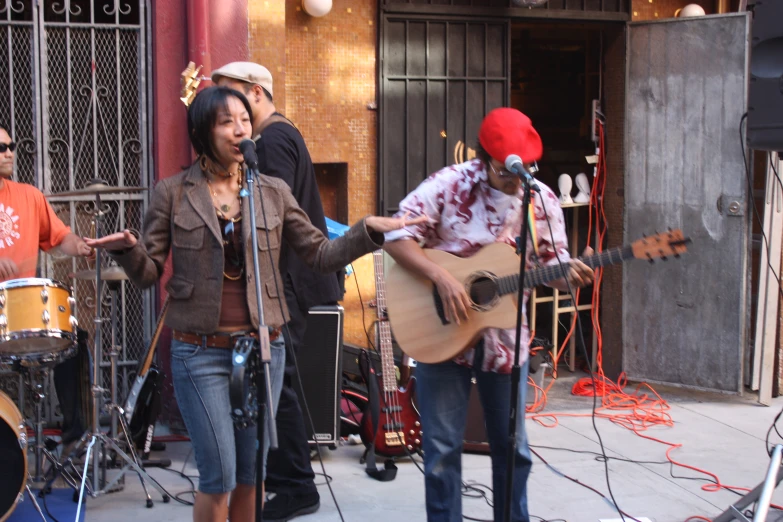 people playing musical on a city street