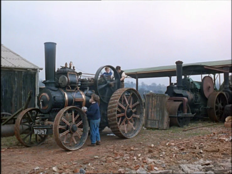 a group of people standing around a train engine