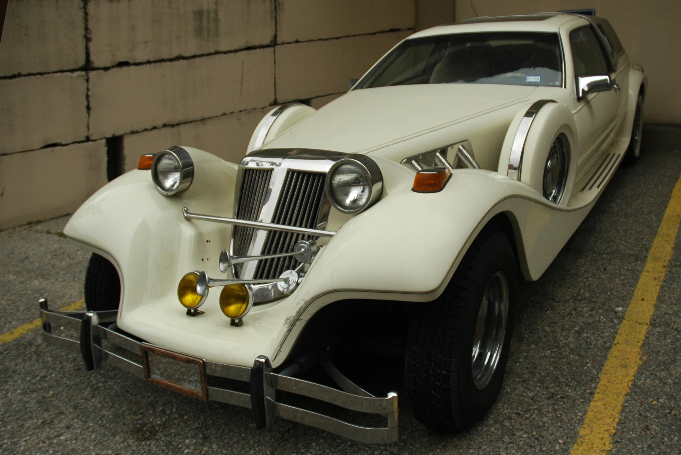 a close up of a car near a wall