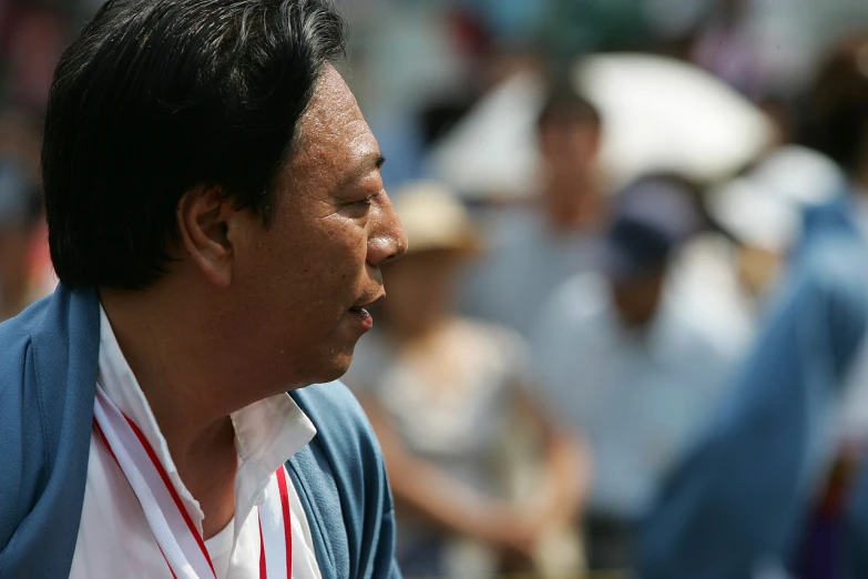 a man walking through an open area with people