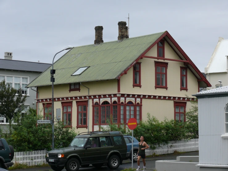 two cars parked in front of a house