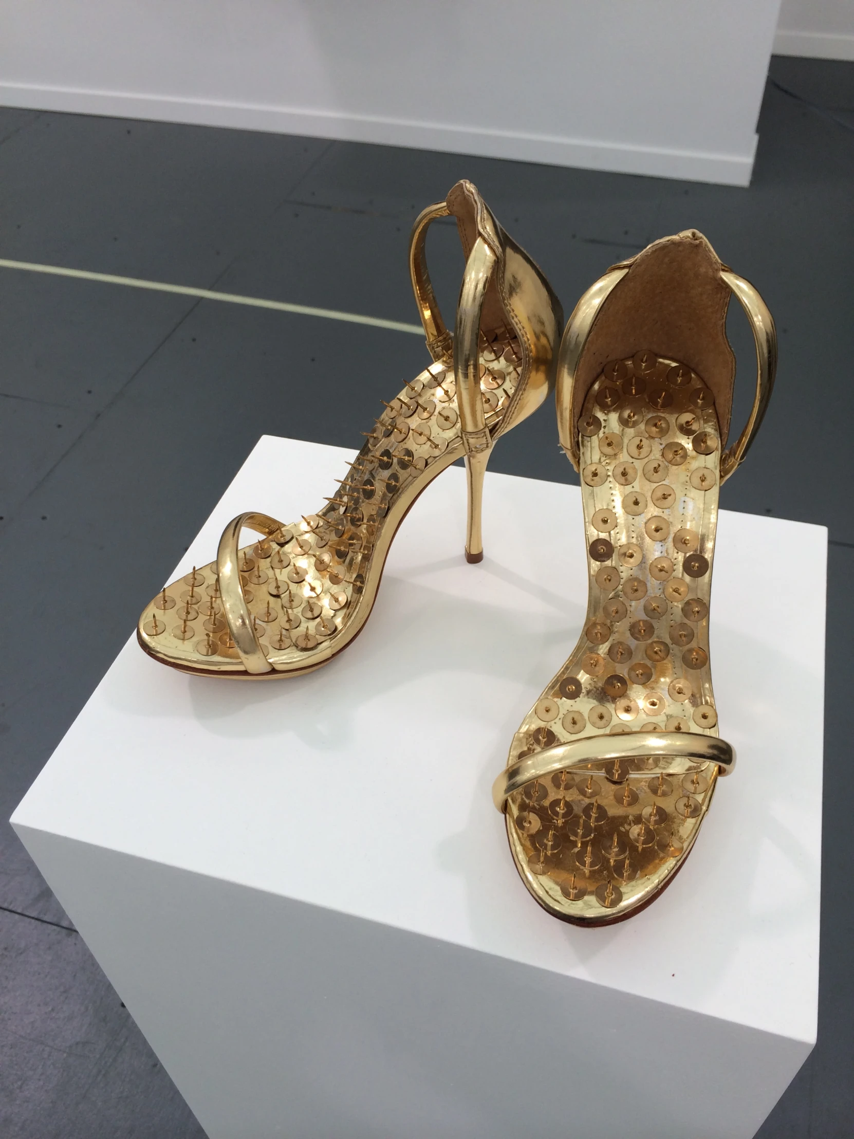 a pair of high heels with metallic heels on display