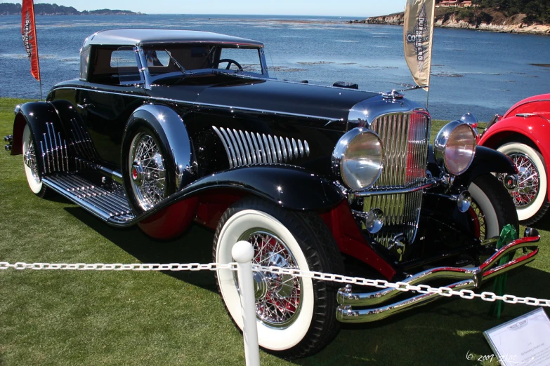 a car is on display in front of some water