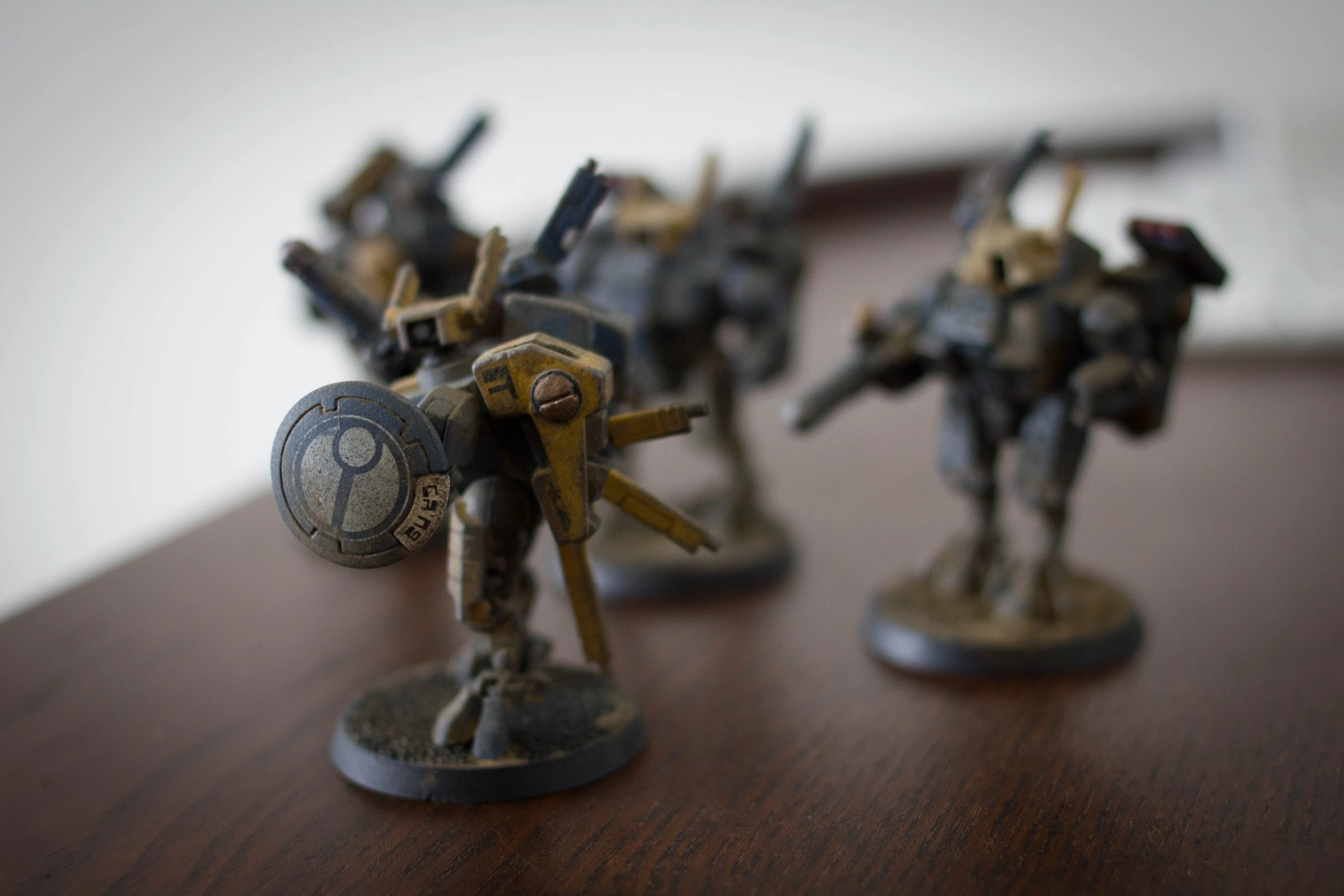 some small metal model army figurines on a table