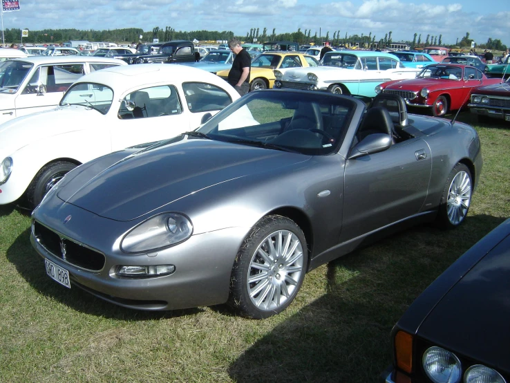 many old cars are parked on the grass