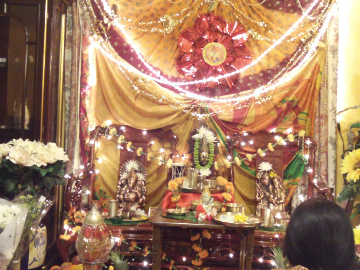 a man sits in a room decorated with lights