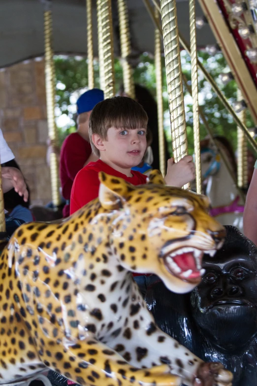 a  riding on the back of a cheetah on a carnival ride