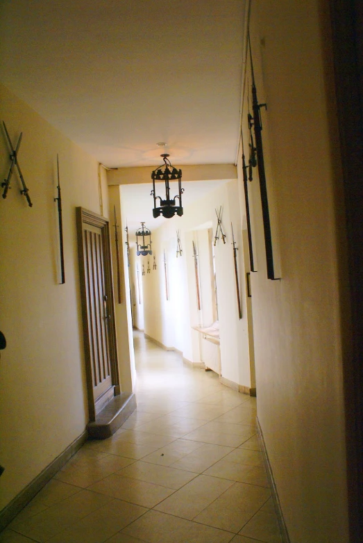 an open hallway with chandeliers and lighting