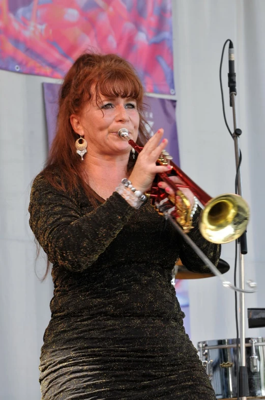 a person in a dress playing a trombone