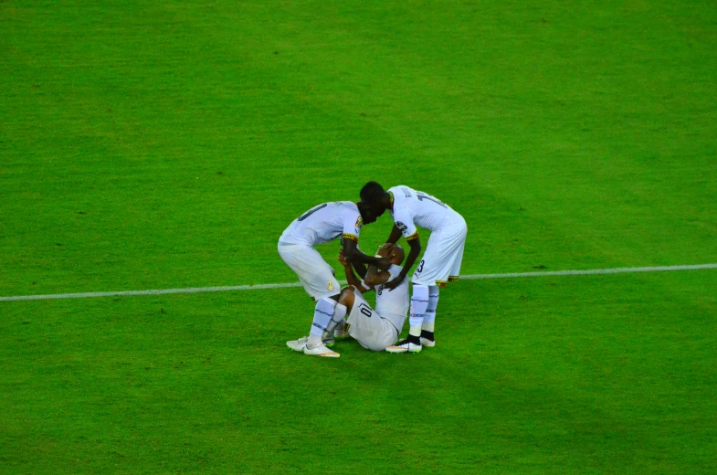 three people are standing around in a field