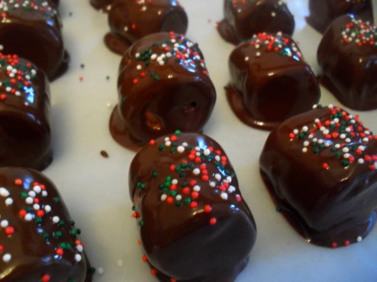 pieces of chocolate covered in sprinkles on top of white tray