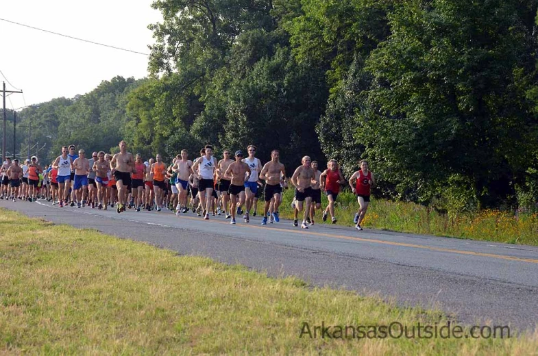 a large group of people on the road with runners