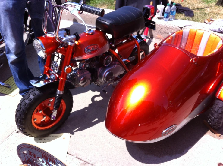 the side view of a small red motorcycle