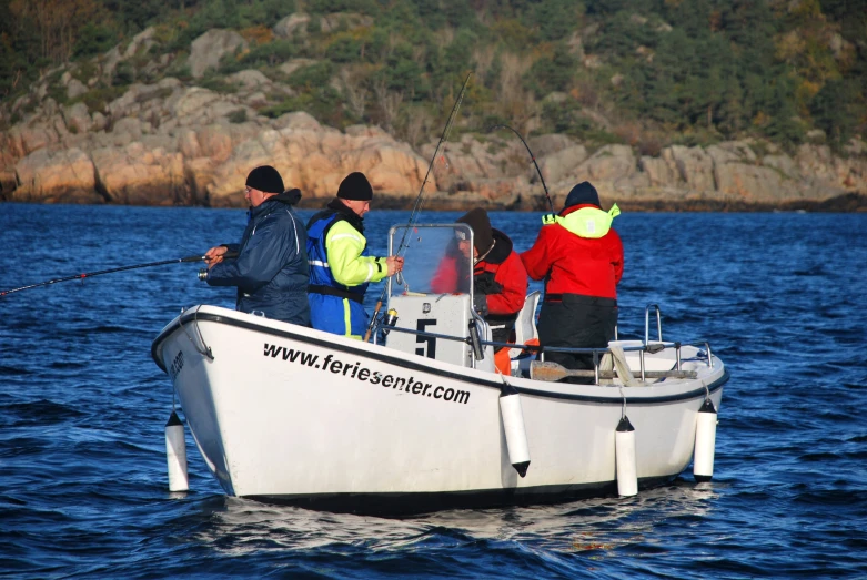 a group of people fishing off of a small boat