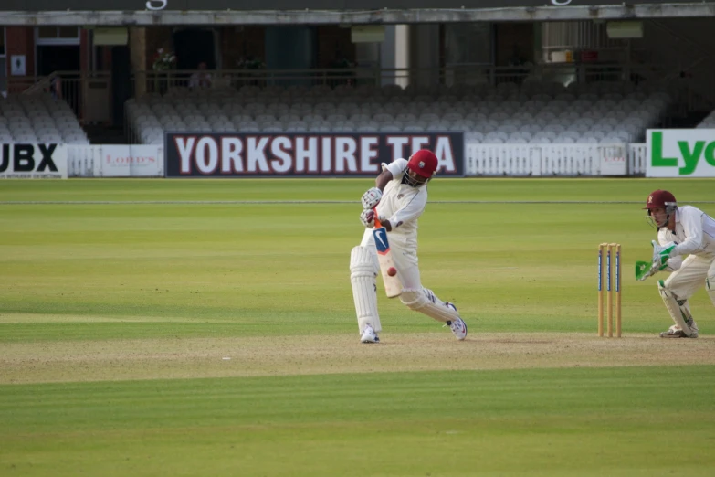 cricket players playing a game in front of a crowd