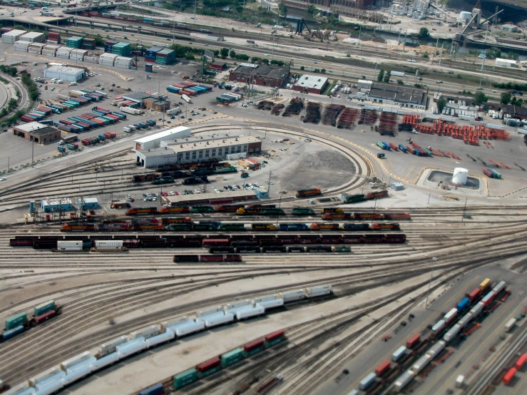 a city is pictured with many trains on the tracks