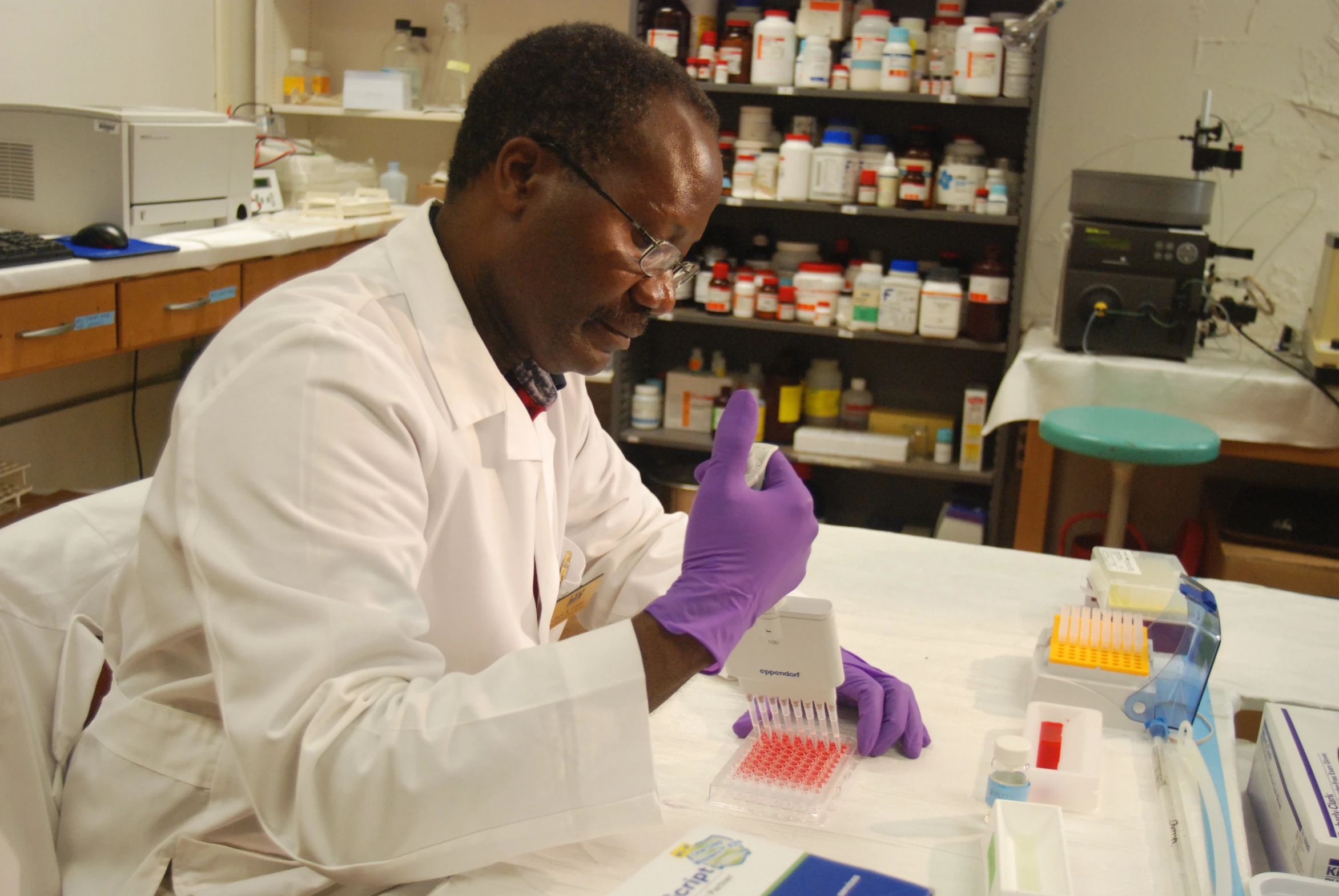 a scientist in a laboratory looking at a test tube