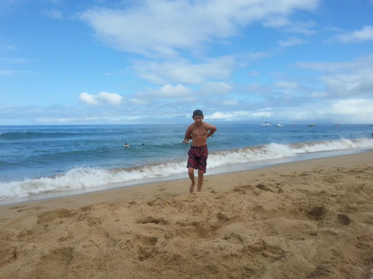 a man standing on the beach, with 