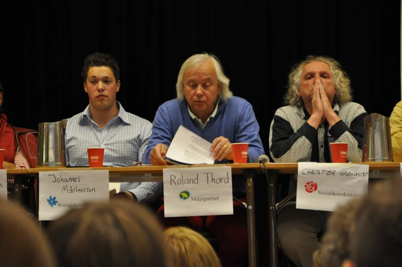 the panel at a community meeting discussing their topics