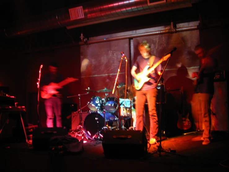 a group of men playing on guitar and singing