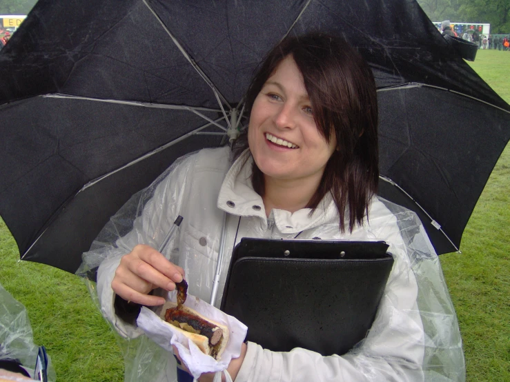 a young woman holding an open umbrella near a  dog