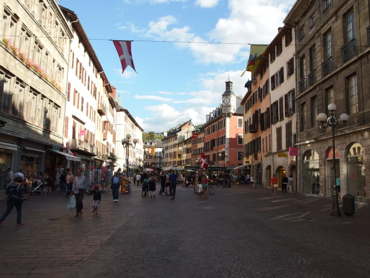 a bunch of people on a cobblestone road