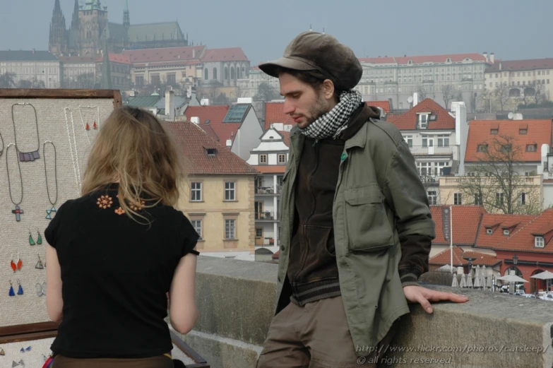 a woman stands next to a man standing on the bridge