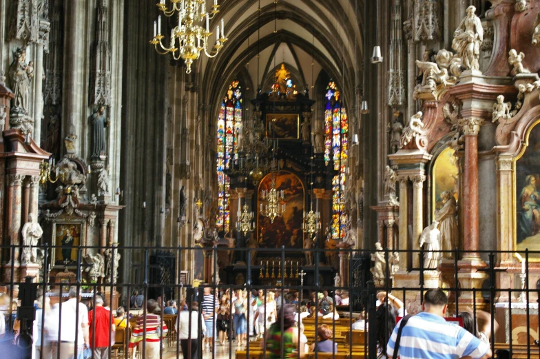 inside an ornately decorated cathedral with lots of people