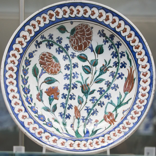 decorative plate with blue, orange and white flowers