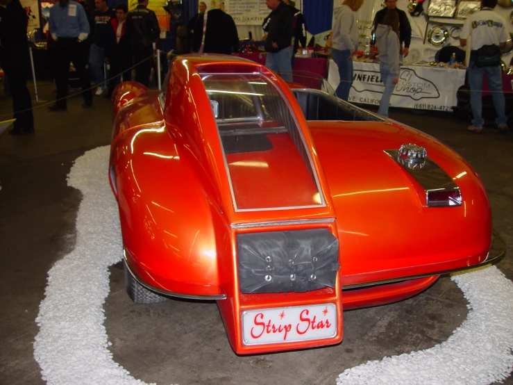 this orange car is very unusual to drive