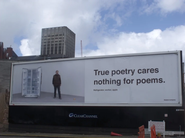 a billboard on a road saying true poetry cares nothing for pooms