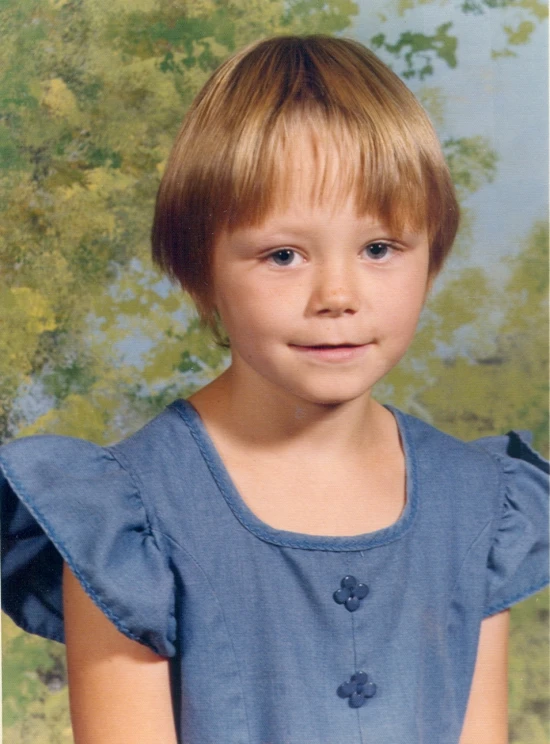 a very cute little boy in blue with blonde hair