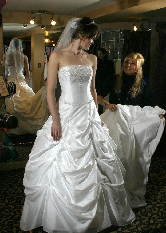 the bride is preparing to walk down the aisle in her wedding dress