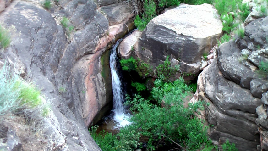 a waterfall running out of the side of a cliff