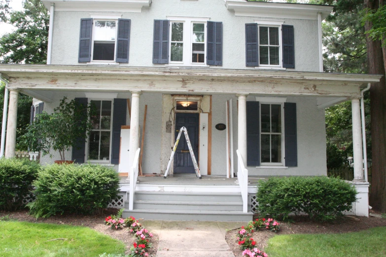 a gray painted house with two steps in front